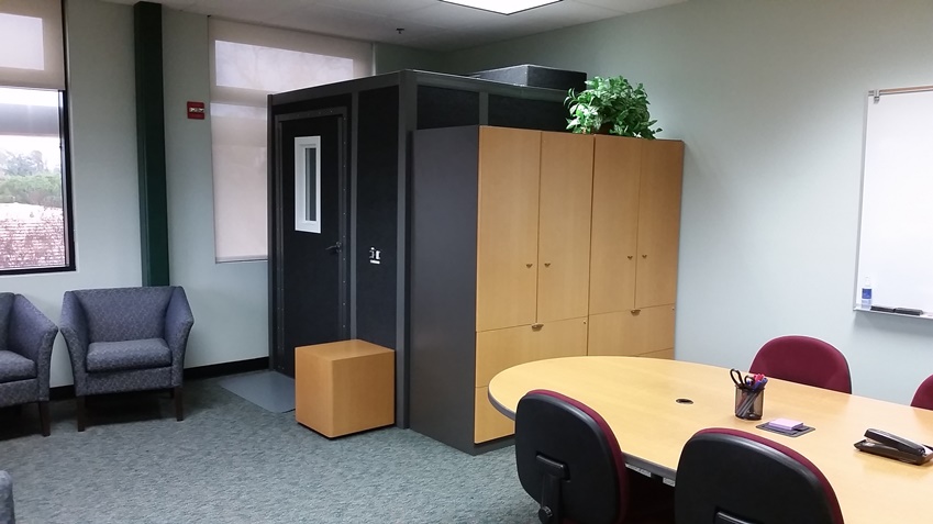 Back cabinets and entry to the audio and video recording sound booth.